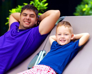 father and son sitting outside