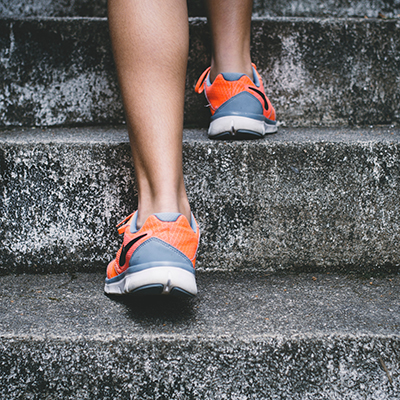 orange sneakers on cement stairs